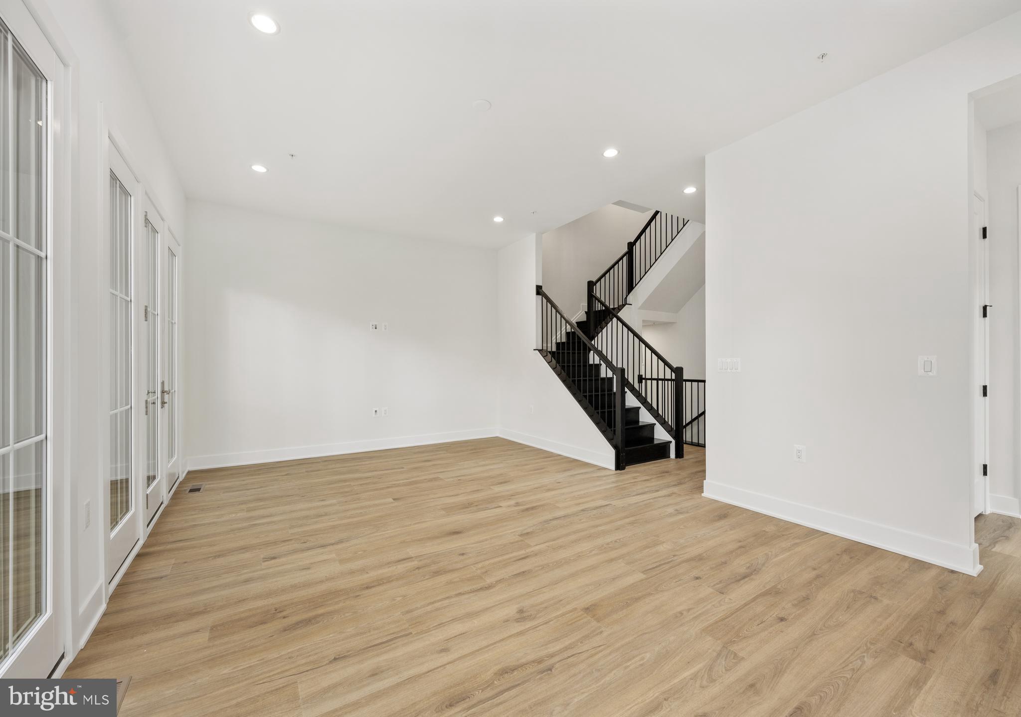 8616 Erdem Place Chevy Chase, MD 20815 - Photo 8 of 12 a view of an empty room with wooden floor and stairs
