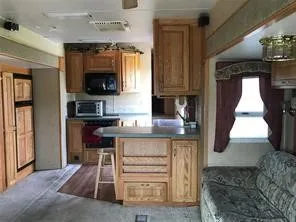 a kitchen with a refrigerator and a stove top oven