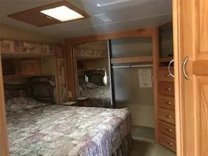 a bedroom with a bed and a mirror
