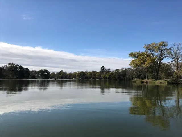 a view of a lake with houses in the background