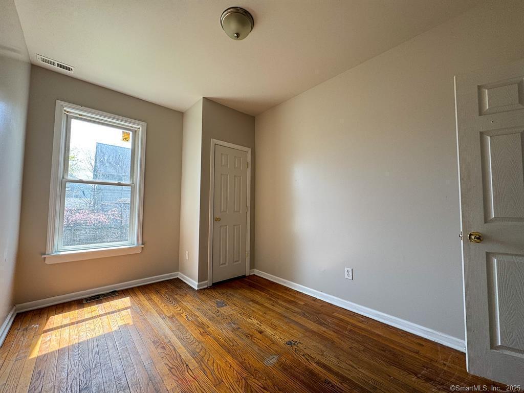 40 Jane Street Bridgeport, CT 06608 - Photo 11 of 29 an empty room with wooden floor and windows