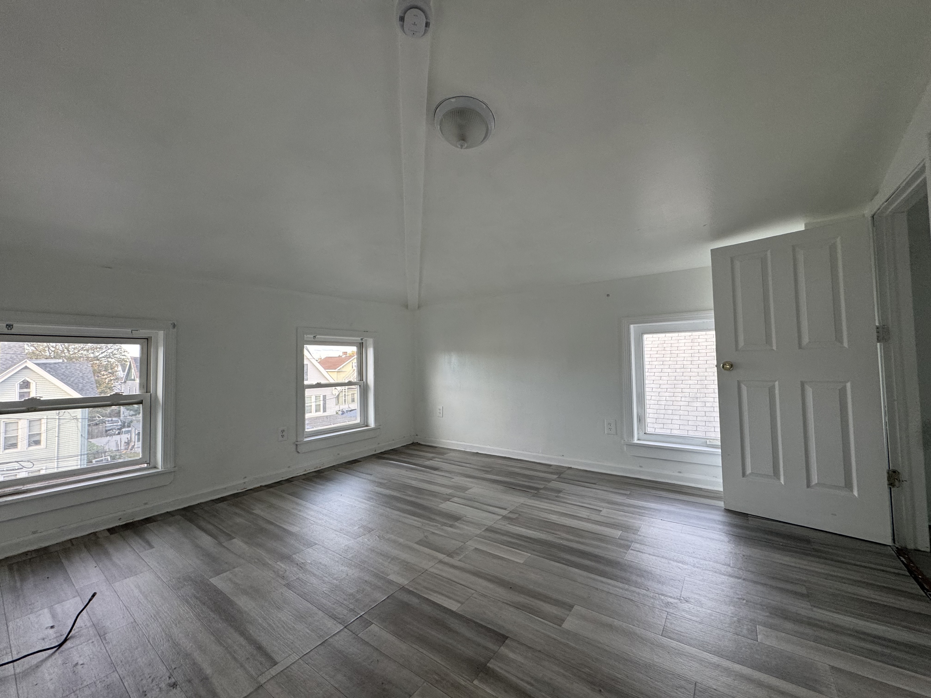 40 Jane Street Bridgeport, CT 06608 - Photo 18 of 29 an empty room with wooden floor and windows