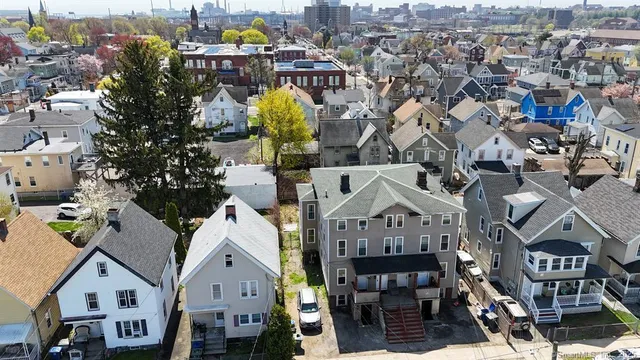 an aerial view of a residential apartment building with a outdoor space and seating area