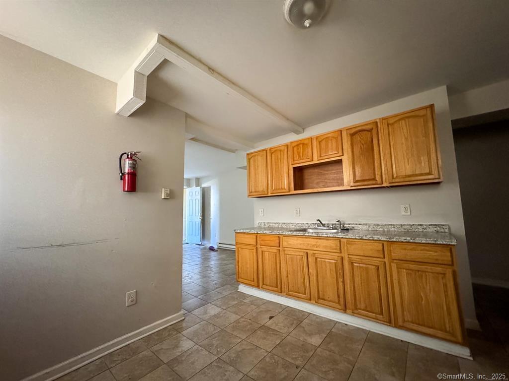 40 Jane Street Bridgeport, CT 06608 - Photo 23 of 29 a room with stainless steel appliances wooden cabinets and a sink