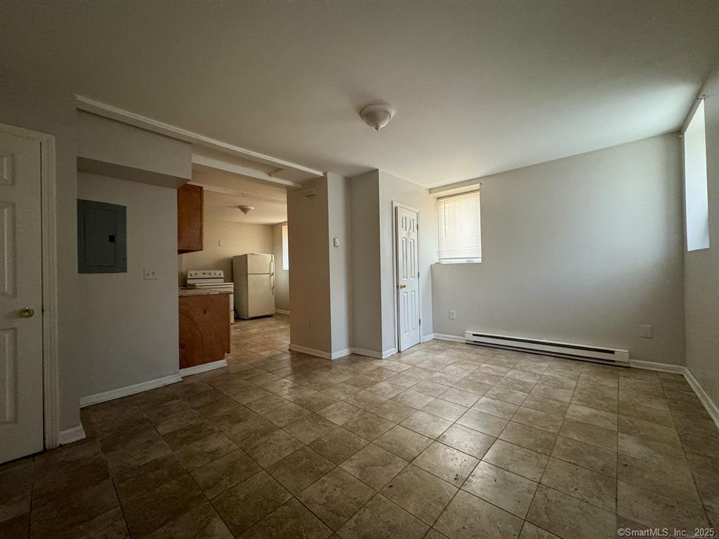 40 Jane Street Bridgeport, CT 06608 - Photo 26 of 29 an empty room with kitchen and refrigerator