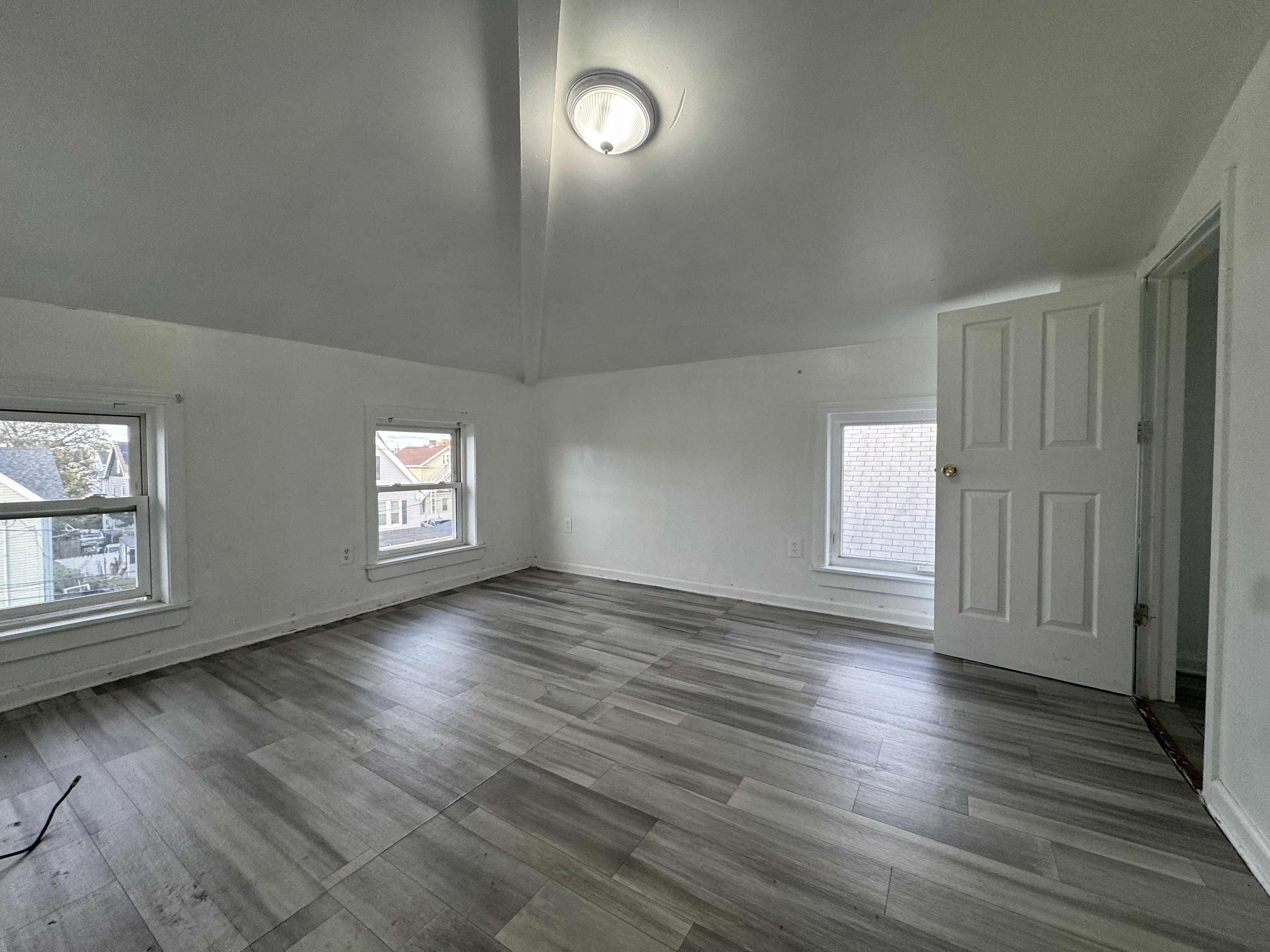 40 Jane Street Bridgeport, CT 06608 - Photo 27 of 29 an empty room with wooden floor and windows