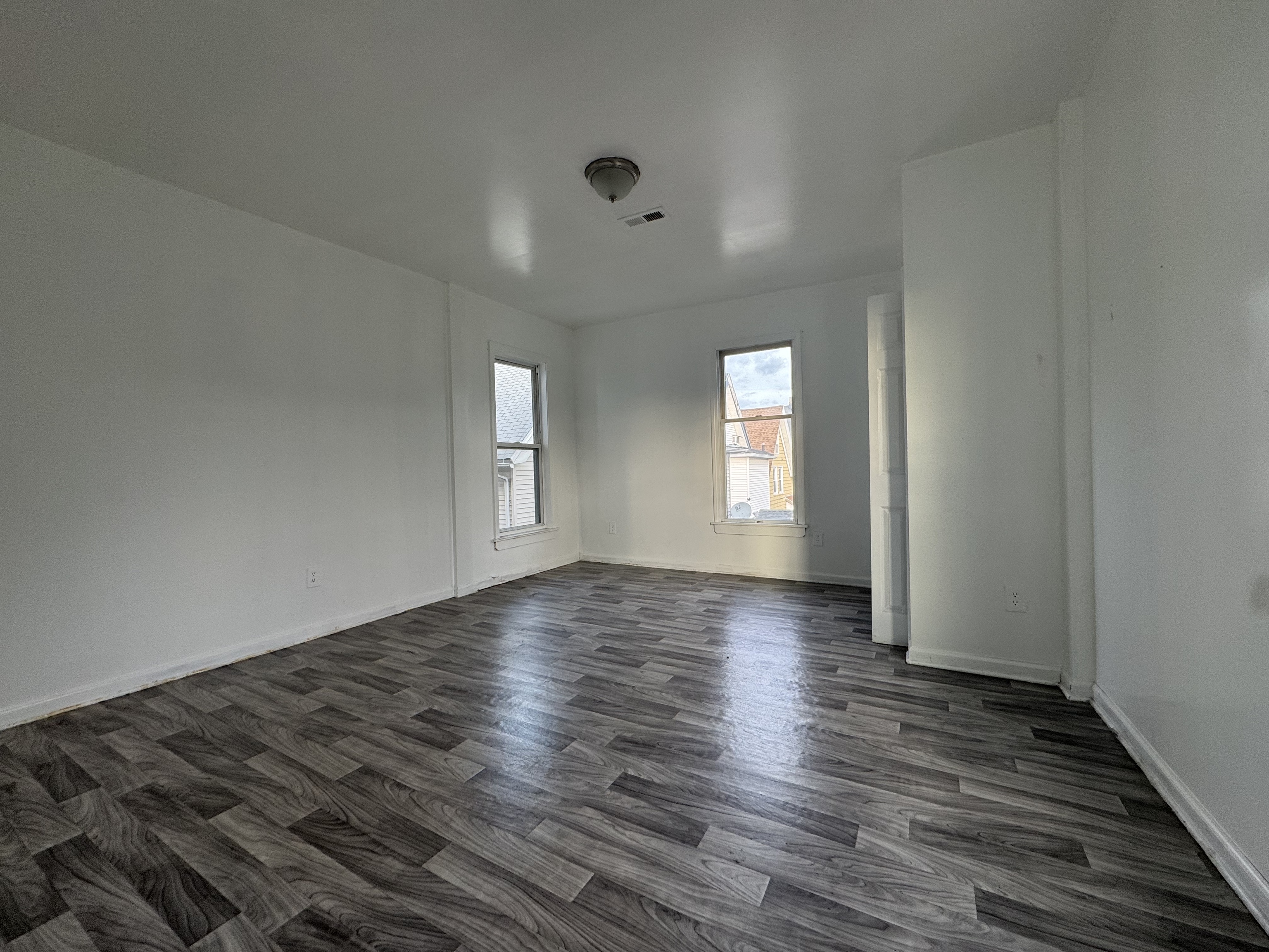 40 Jane Street Bridgeport, CT 06608 - Photo 5 of 29 a view of an empty room with wooden floor and a window