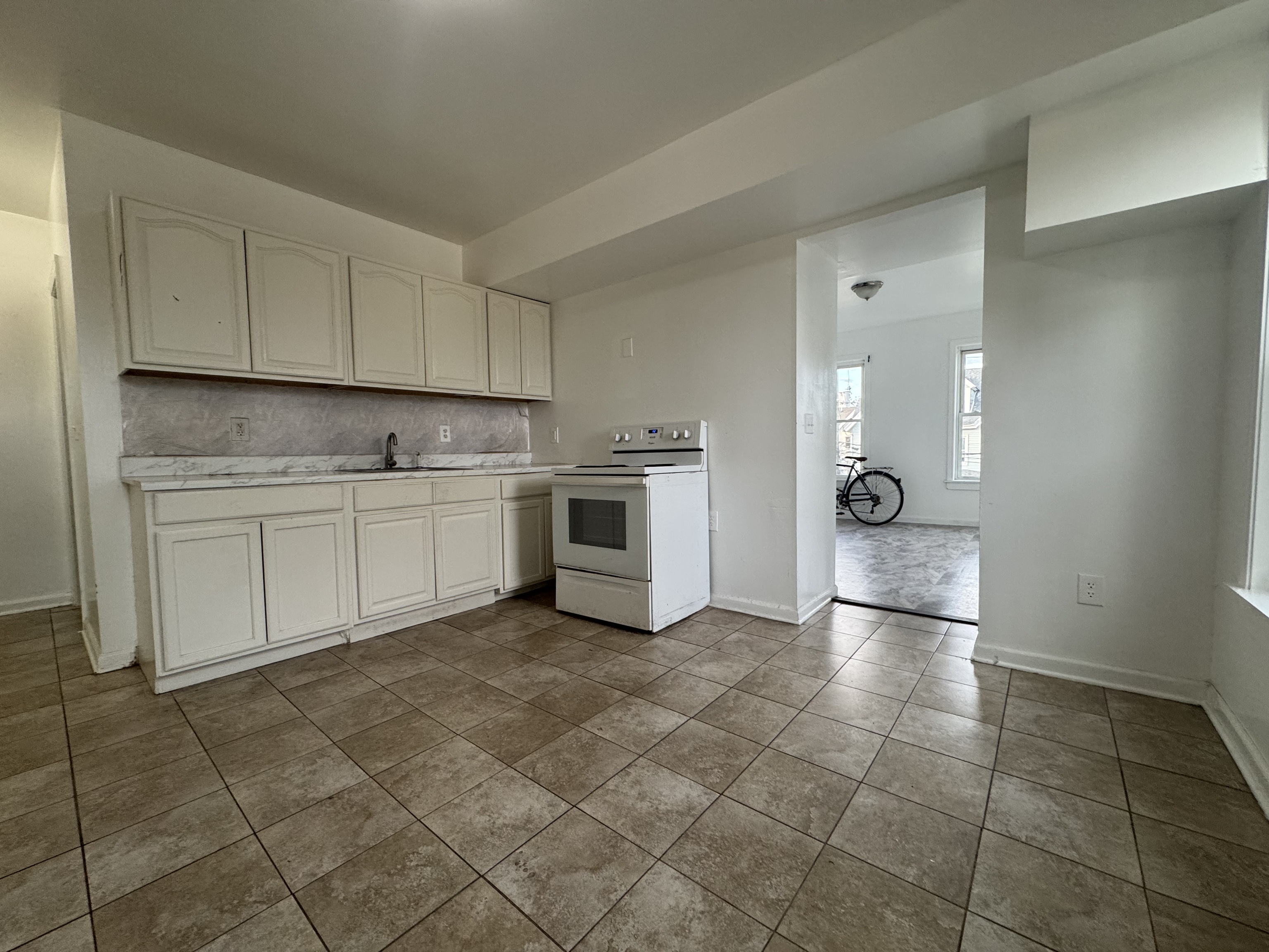 40 Jane Street Bridgeport, CT 06608 - Photo 7 of 29 a kitchen with a sink a stove and cabinets