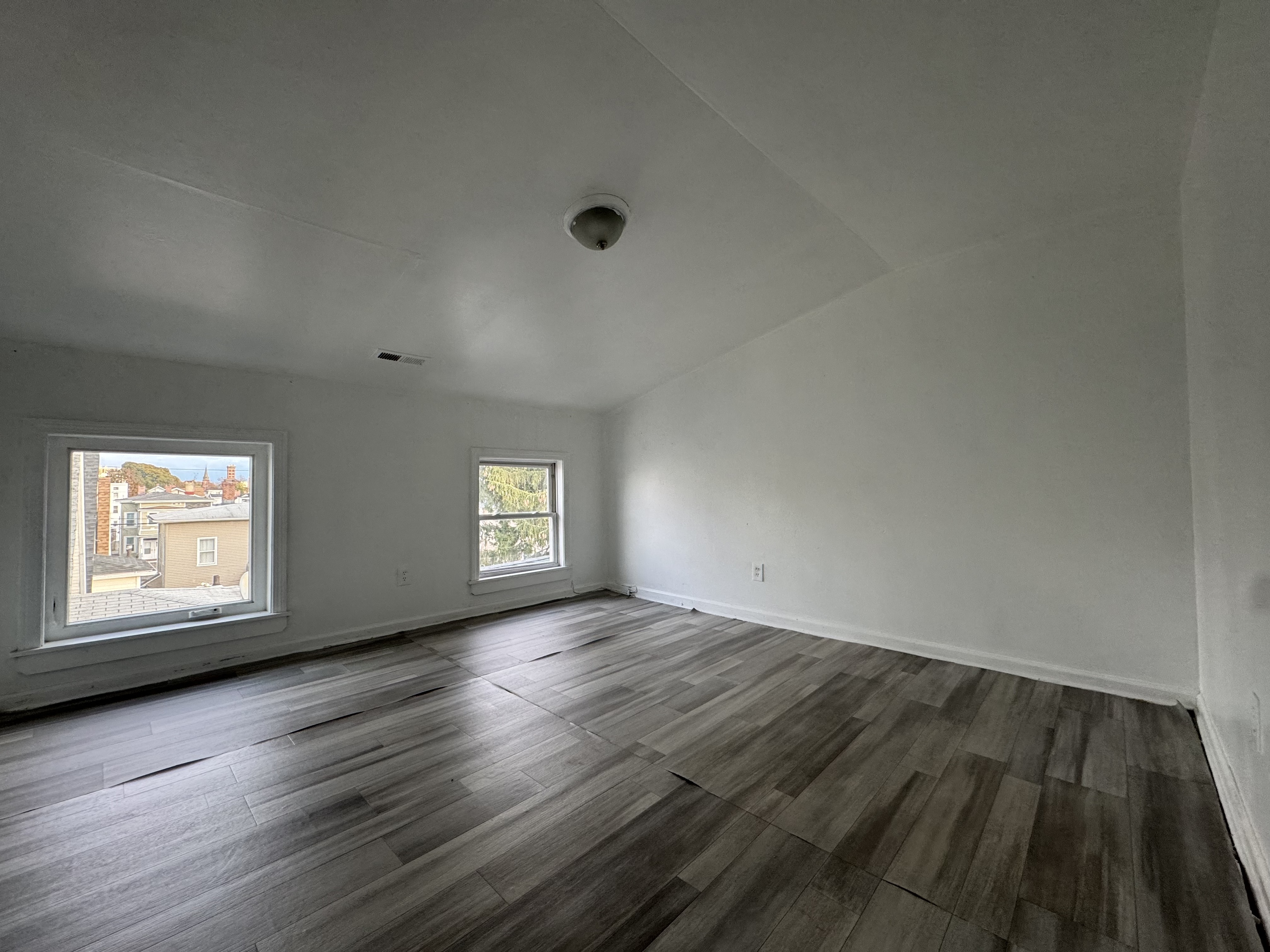 40 Jane Street Bridgeport, CT 06608 - Photo 8 of 29 an empty room with wooden floor and windows