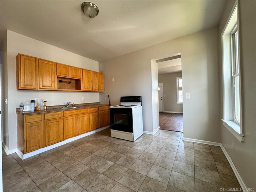 40 Jane Street Bridgeport, CT 06608 - Photo 10 of 29 a large kitchen with stainless steel appliances granite countertop a stove a sink and a refrigerator