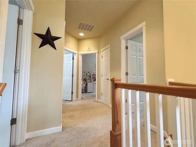 a view of a hallway view with staircase