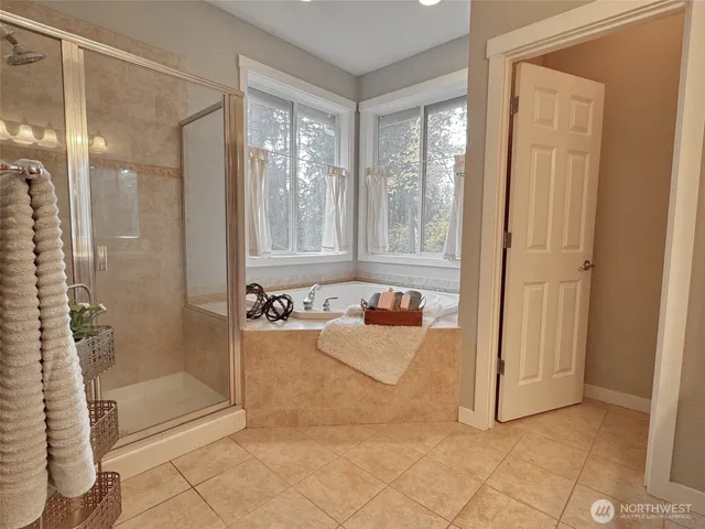 a bathroom with shower tub and window