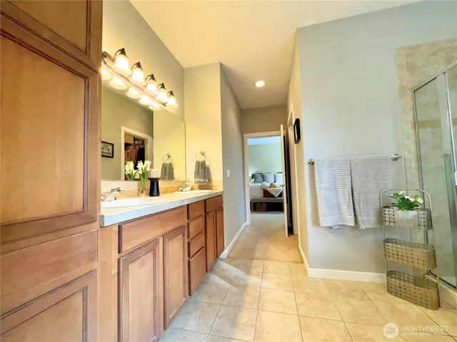 a large bathroom with a glass door shower and sink