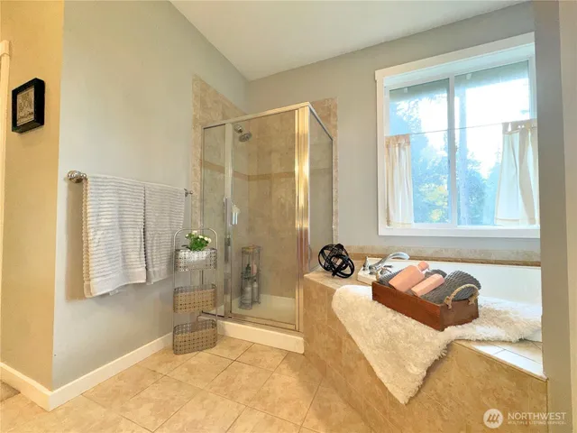 a spacious bedroom with a bed and a couch