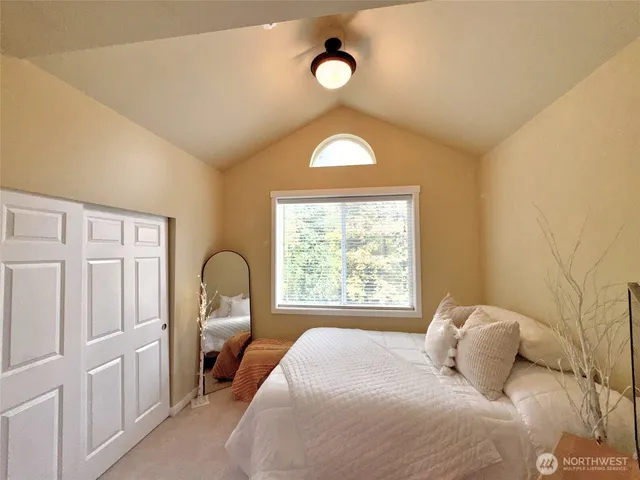 a bedroom with a bed and a window