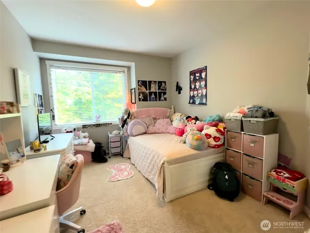 a bedroom with a bed and a couch