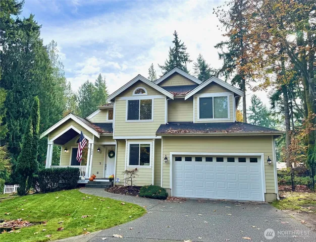a front view of a house with a garden and plants