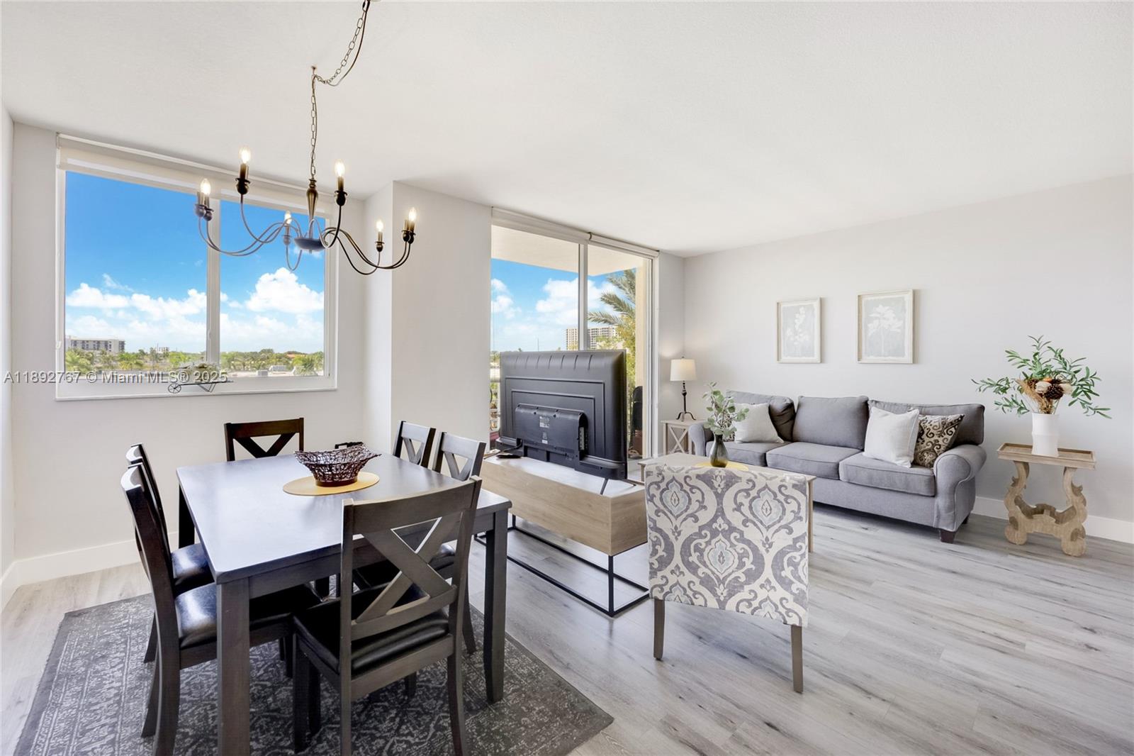 2775 Northeast 187th Street, Unit 309 Aventura, FL 33180 - Photo 13 of 21 a view of a dining room with furniture window and wooden floor