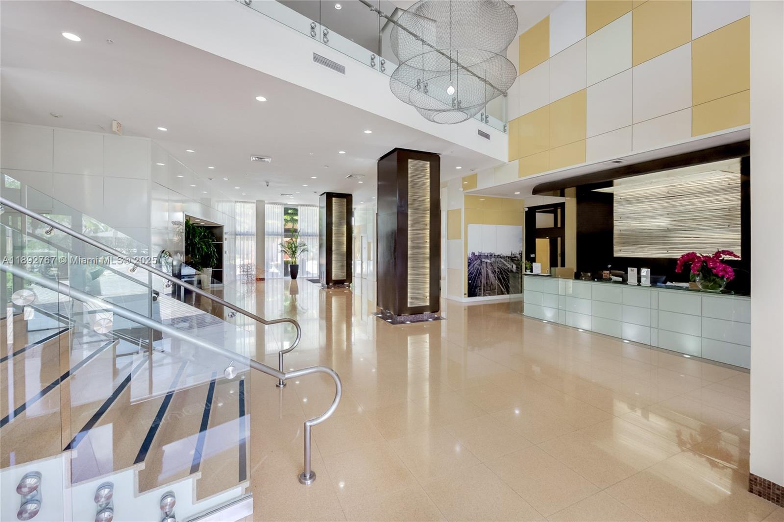 2775 Northeast 187th Street, Unit 309 Aventura, FL 33180 - Photo 15 of 21 a lobby with furniture and a flat screen tv