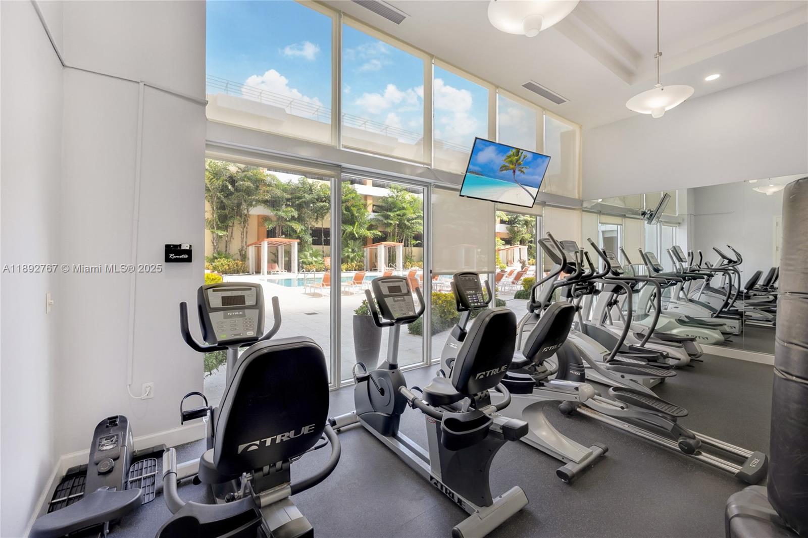 2775 Northeast 187th Street, Unit 309 Aventura, FL 33180 - Photo 17 of 21 a room with gym equipment and windows