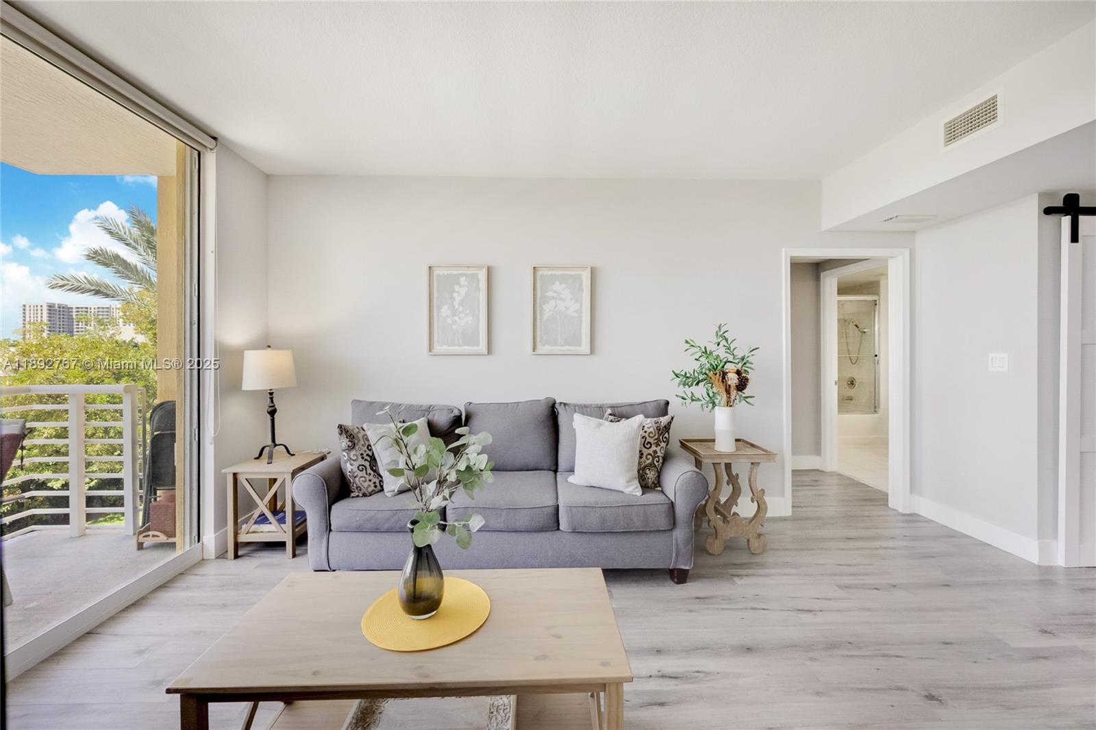 2775 Northeast 187th Street, Unit 309 Aventura, FL 33180 - Photo 5 of 21 a living room with furniture and wooden floor