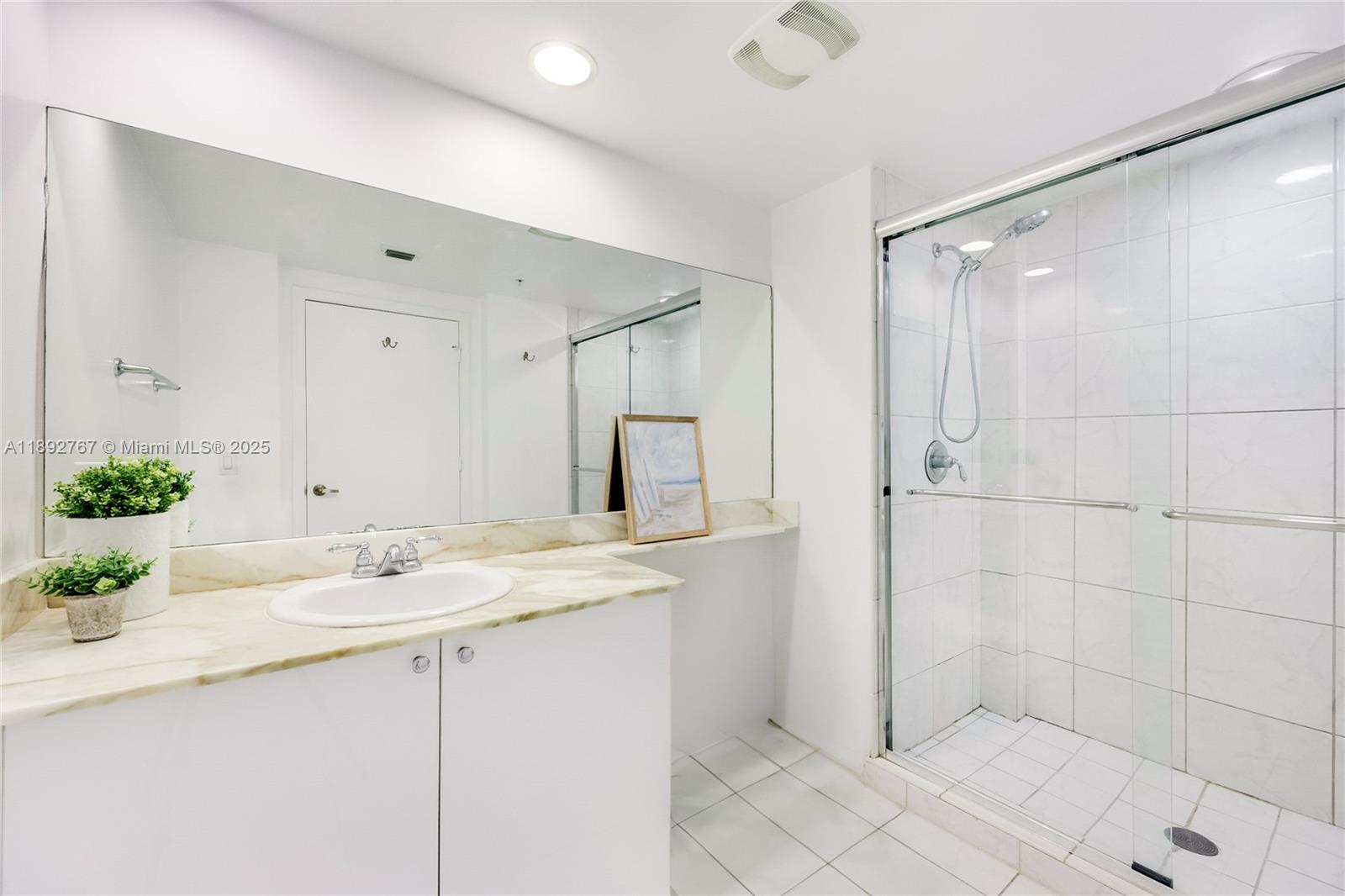 2775 Northeast 187th Street, Unit 309 Aventura, FL 33180 - Photo 7 of 21 a bathroom with a shower sink and vanity