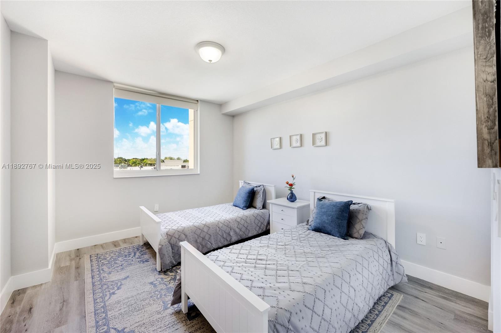 2775 Northeast 187th Street, Unit 309 Aventura, FL 33180 - Photo 9 of 21 a bedroom with two beds and a table