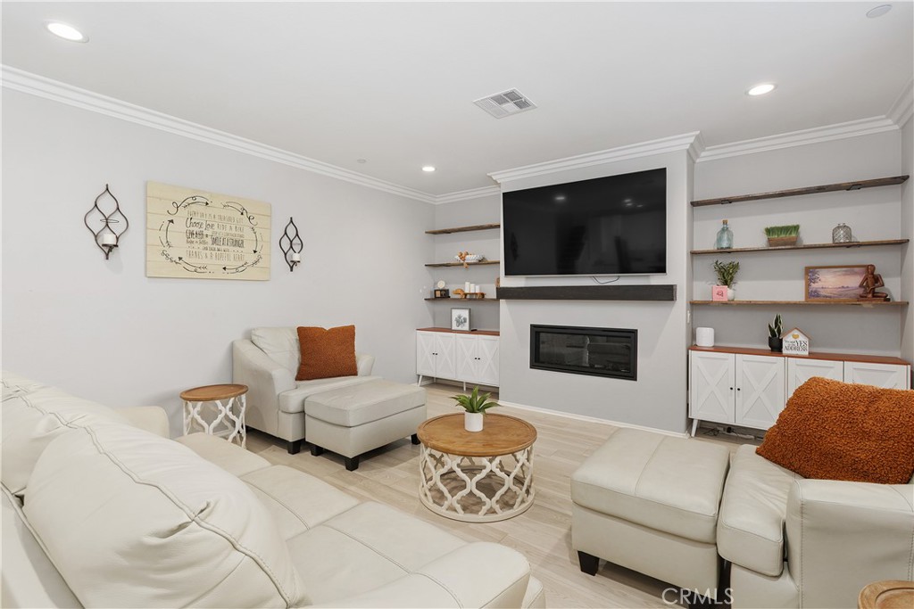 3056 Eveningcloud Street Hemet, CA 92543 - Photo 12 of 48 a living room with furniture a flat screen tv and a fireplace