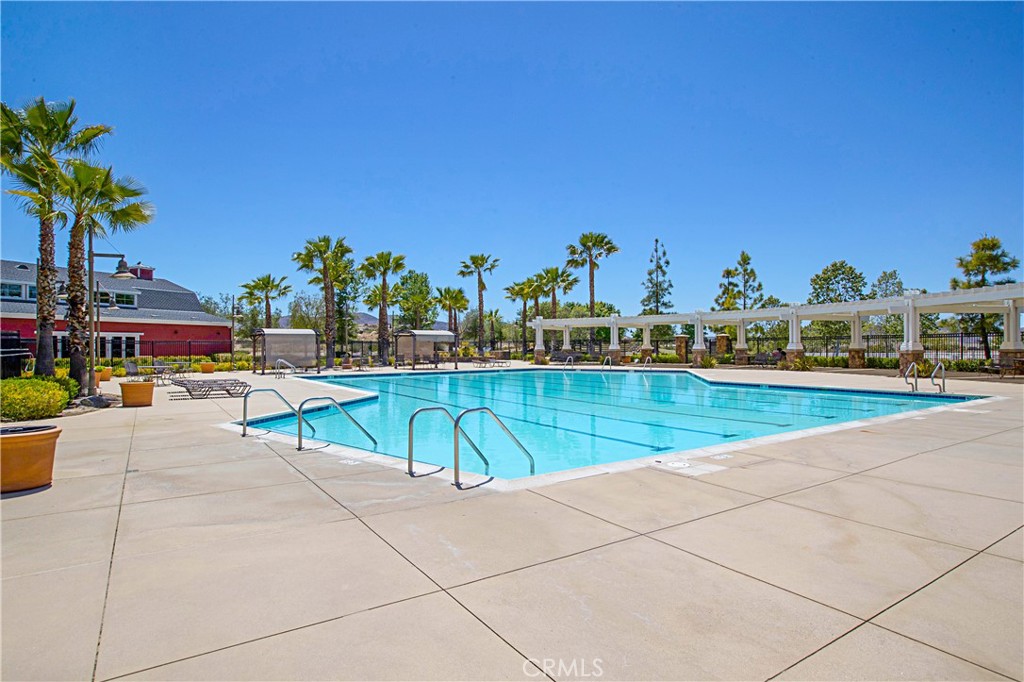 3056 Eveningcloud Street Hemet, CA 92543 - Photo 36 of 48 a view of a swimming pool and lounge chairs