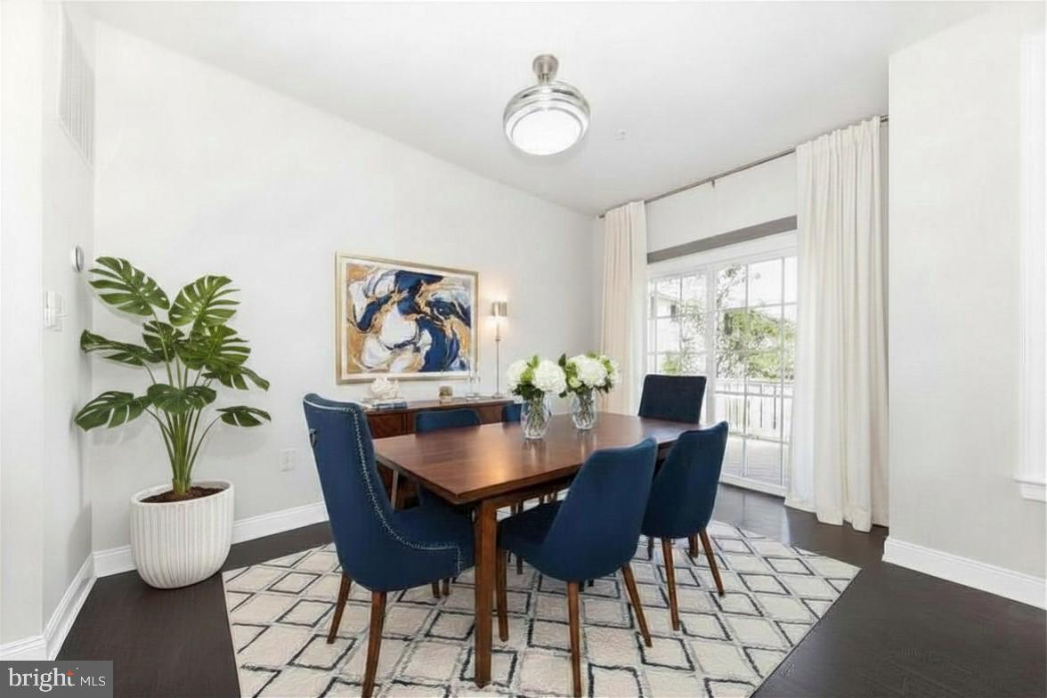 2325 Asberry Road Hanover, MD 21076 - Photo 20 of 65 a dining room with furniture potted plants and wooden floor