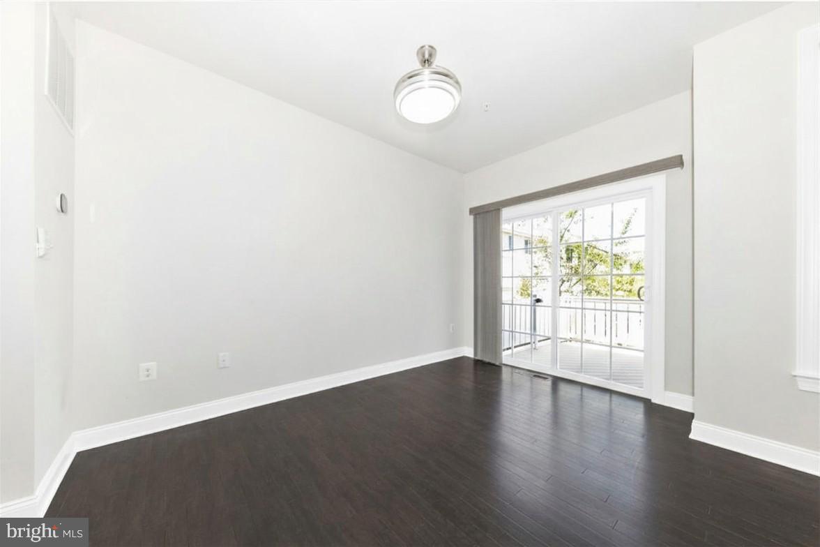 2325 Asberry Road Hanover, MD 21076 - Photo 21 of 65 an empty room with wooden floor and windows