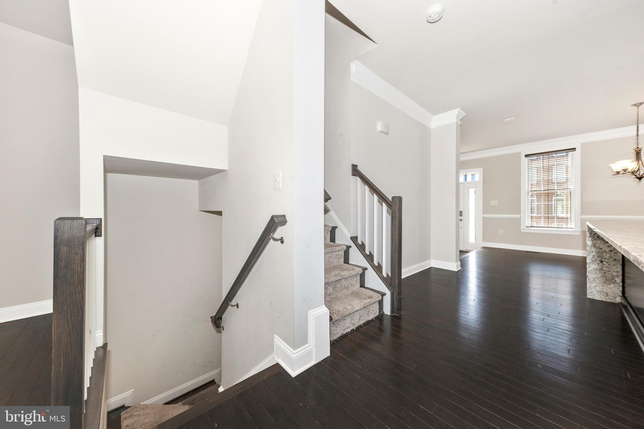2325 Asberry Road Hanover, MD 21076 - Photo 22 of 65 a view of a hallway with wooden floor and stairs
