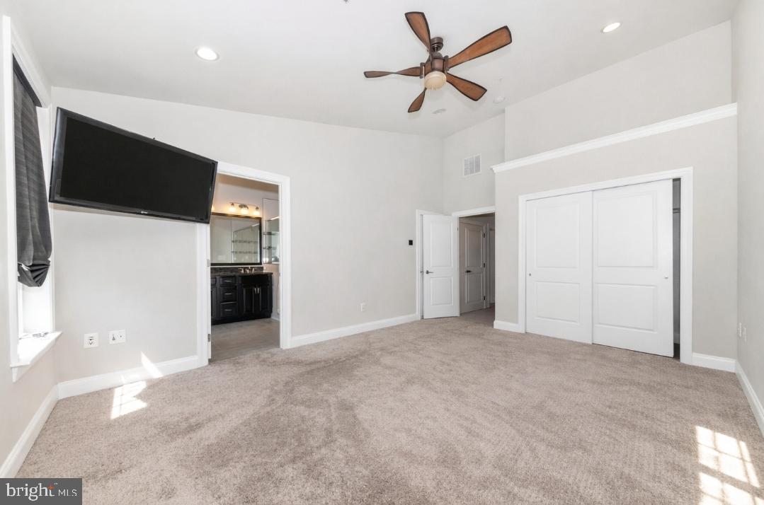 2325 Asberry Road Hanover, MD 21076 - Photo 25 of 65 a view of a livingroom with a ceiling fan and a kitchen