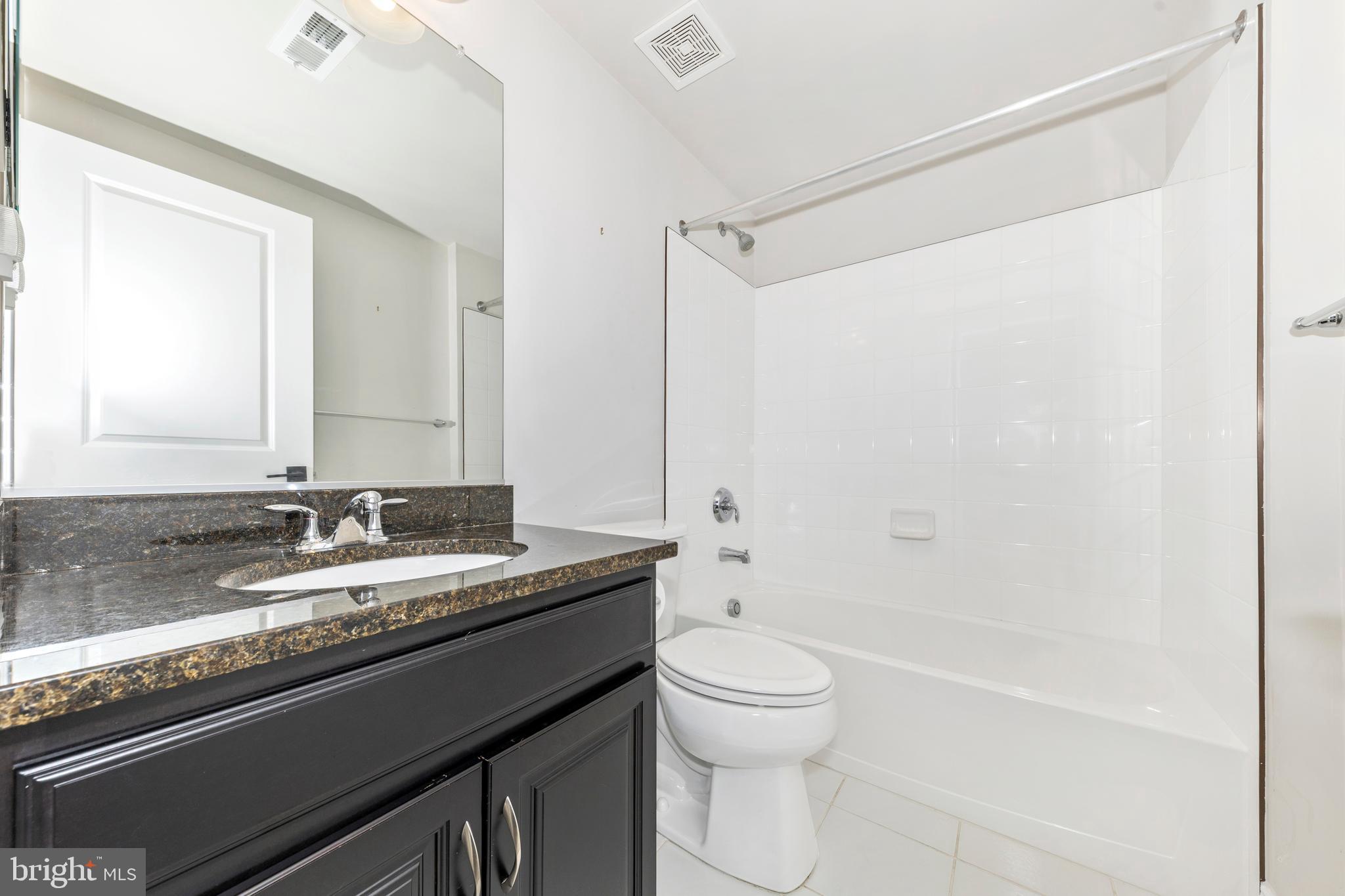 2325 Asberry Road Hanover, MD 21076 - Photo 41 of 65 a bathroom with a granite countertop sink toilet and shower