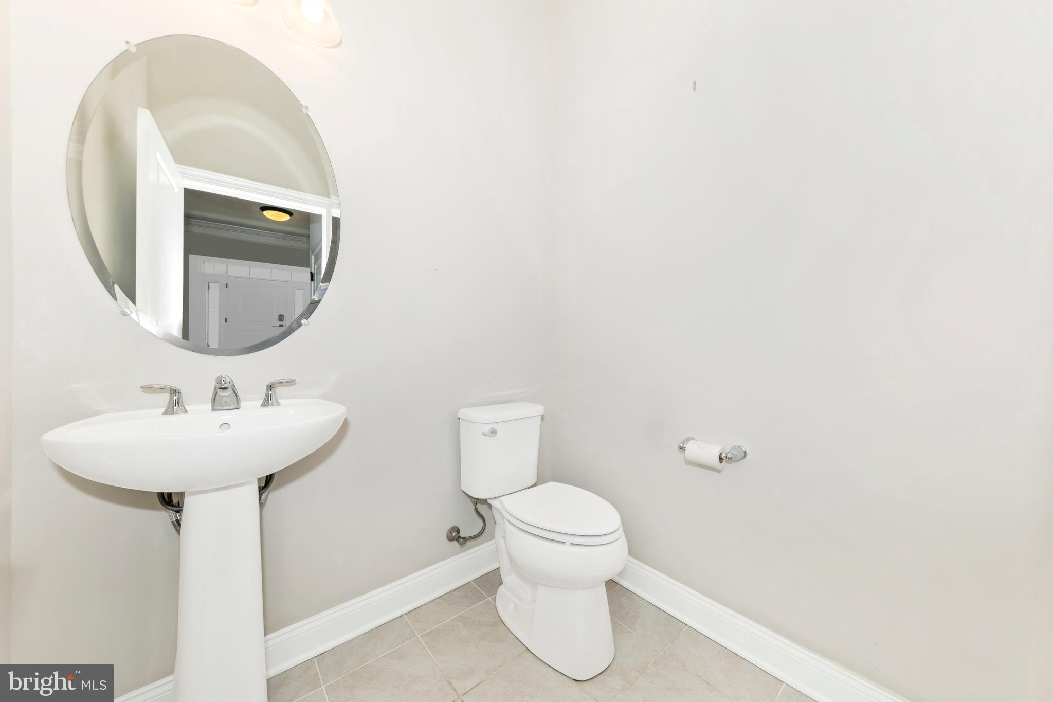 2325 Asberry Road Hanover, MD 21076 - Photo 7 of 65 a bathroom with a toilet sink and mirror