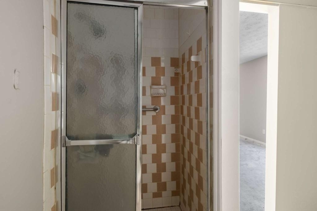 3254 Strawberry Lane Decatur, GA 30034 - Photo 21 of 27 a bathroom with a glass shower door