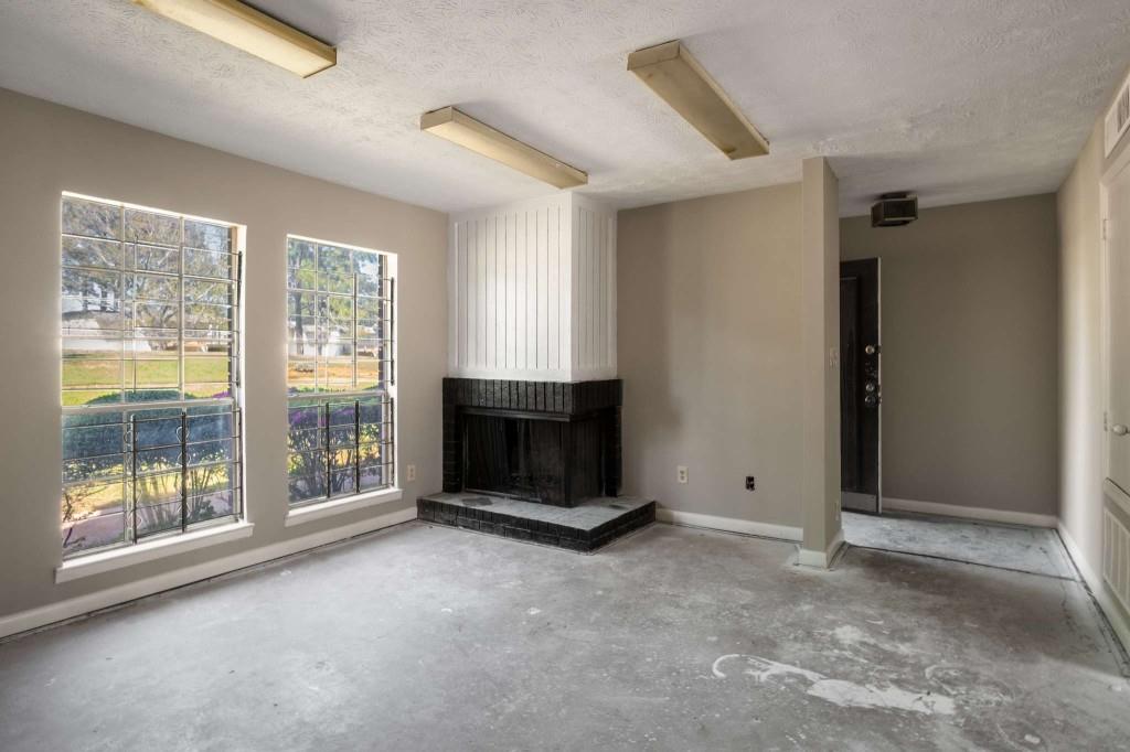 3254 Strawberry Lane Decatur, GA 30034 - Photo 8 of 27 a view of an empty room with a fireplace and a window