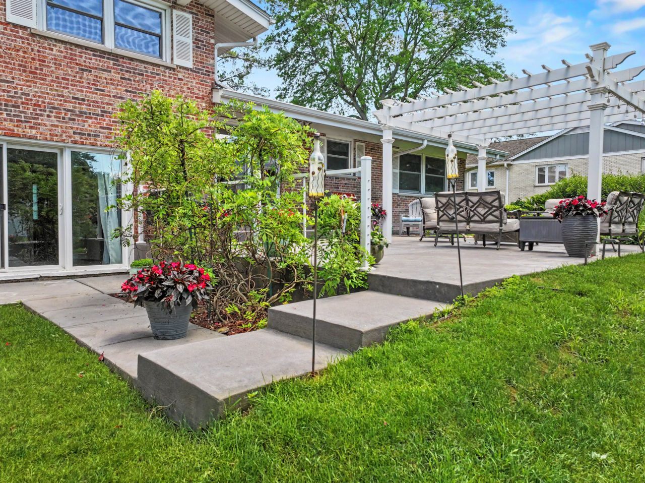328 Windsor Lane Inverness, IL 60010 - Photo 28 of 33 a view of a patio with table and chairs potted plants and a large tree