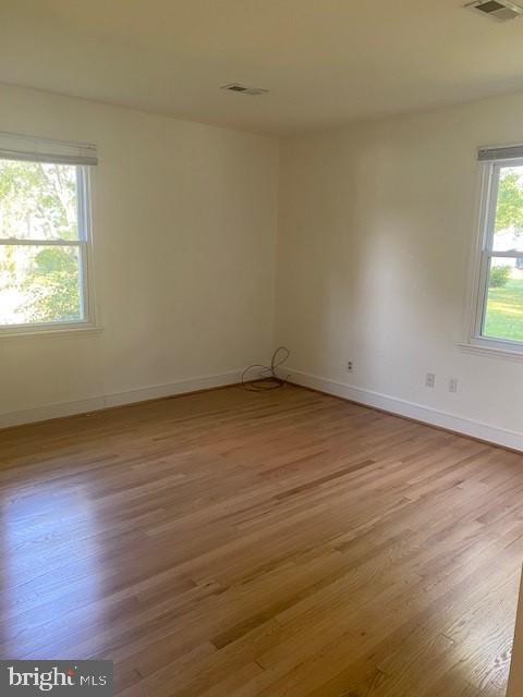 12209 Baines Corner Road Bealeton, VA 22712 - Photo 8 of 14 an empty room with wooden floor and windows