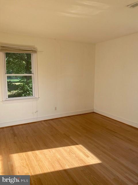 12209 Baines Corner Road Bealeton, VA 22712 - Photo 10 of 14 a view of an empty room with wooden floor and a window