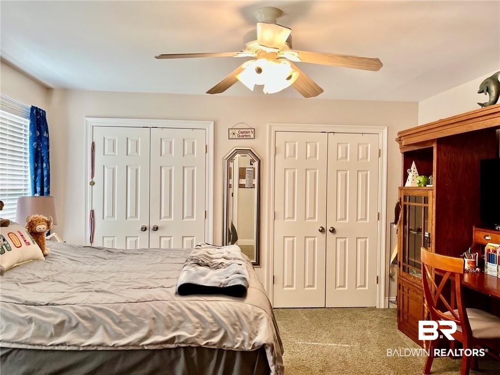 16311 Old Brady Road Bay Minette, AL 36507 - Photo 29 of 38 Recessed window with horizontal blinds, two paneled closet doors with round hardware, and a ceiling fan with light fixture