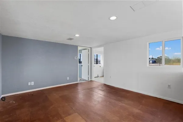 a view of wooden floor and windows in a room
