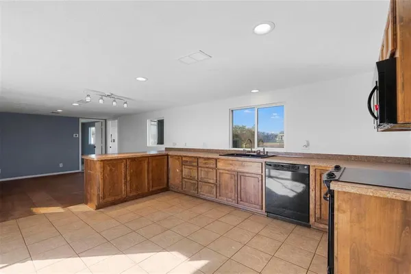 a kitchen with stainless steel appliances granite countertop a sink and cabinets