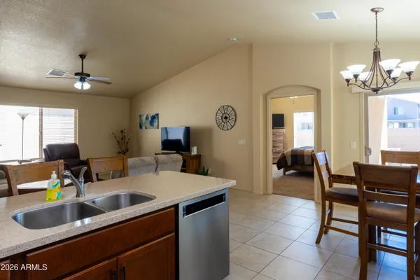 a kitchen with a sink a stove and cabinets