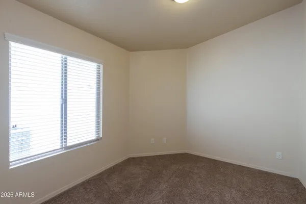 a bedroom with a bed and a wall painting
