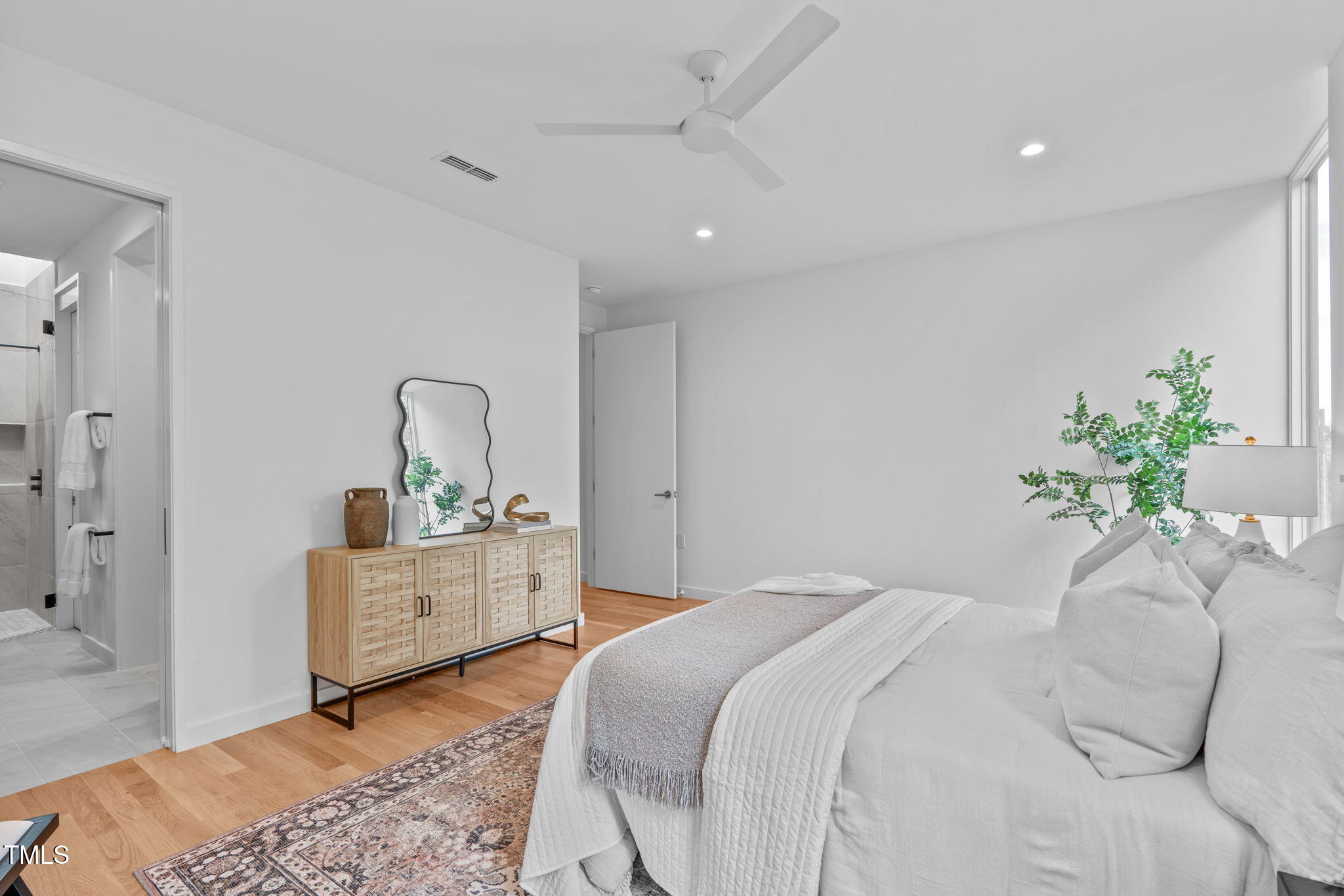 501 South Bloodworth Street, Unit 101 Raleigh, NC 27601 - Photo 26 of 55 a bedroom with a bed and a dresser