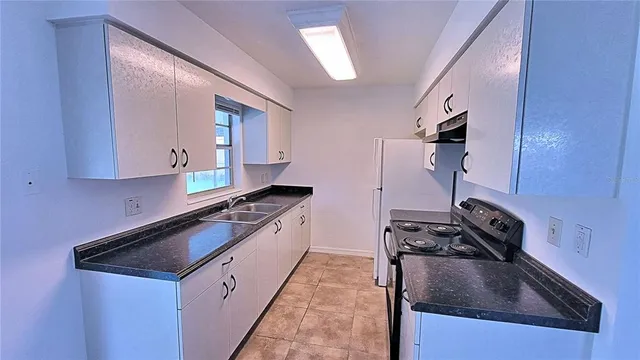 a kitchen that has a sink and a stove