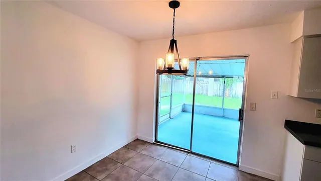 a view of a room with a ceiling fan and a window