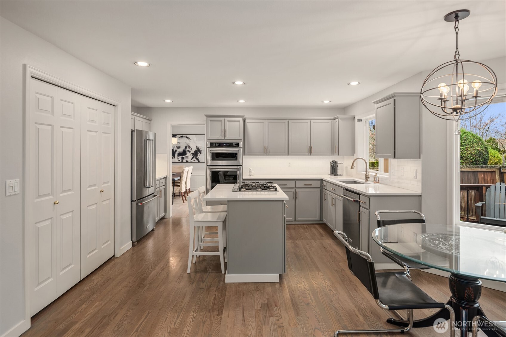 10330 Northeast 151st Place Bothell, WA 98011 - Photo 14 of 38 a kitchen with a table chairs refrigerator and cabinets
