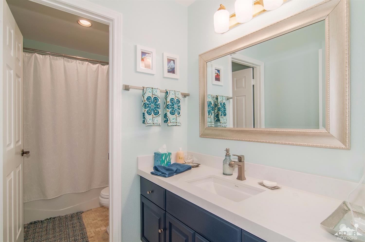 36720 Palmdale Road Rancho Mirage, CA 92270 - Photo 33 of 34 a bathroom with a sink a mirror and a shower